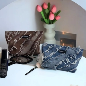 Denim fringe cosmetic bag and striped toiletry organizer with frayed edges and moonshine logo