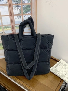 Quilted black puffer tote bag with large capacity and soft padded shoulder straps
