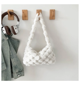Detail view of white plush shoulder bag featuring a soft bubble texture and cozy design