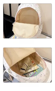 Internal storage detail showing the backpack holding an umbrella, notebook and gadgets