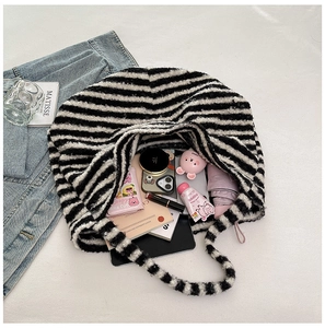 Spacious black and white plaid plush bag showing ample interior storage for daily items