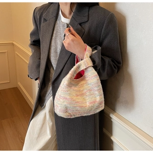 Detailed texture of a colorful striped knit plush handbag with premium mohair finish