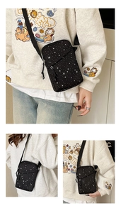 Three-angle view of a black crossbody bag with white star pattern and adjustable strap