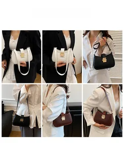 Borsa a spalla stile sella in bianco, nero e marrone con eleganti fibbie dorate