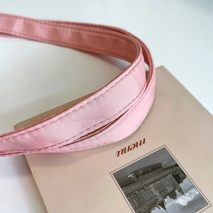 Close-up of reinforced double-stitching and high-density satin fabric handle on pink tote