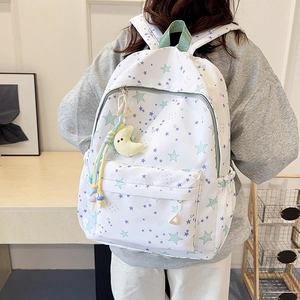 Girl's white backpack with blue and purple stars pattern and plush moon charm