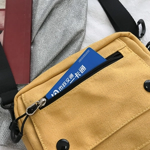 Chic mustard yellow canvas crossbody bag with a functional front zipper pocket