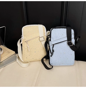 Close-up of stylish nylon crossbody phone bags with star prints and adjustable straps