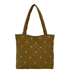 Quilted tote bag with white bow pattern and rhombus stitching for winter style