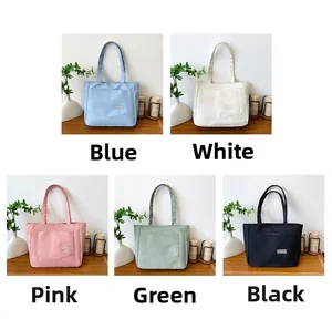 Detailed view of the nylon tote bag available in blue, white, pink, green, and black