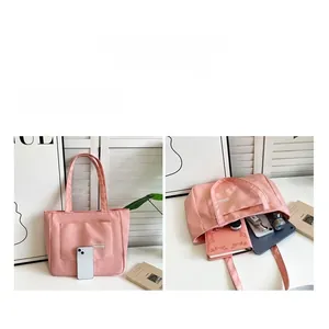 Pink nylon tote bag interior showing large capacity with laptop and accessories