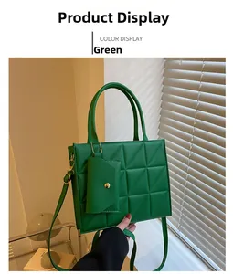 Close-up of green quilted handbag with gold chain detail and small matching coin purse