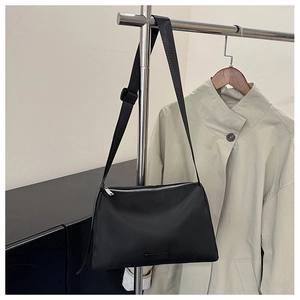 Detailed shot of black nylon crossbody bag with silver zipper and adjustable wide strap