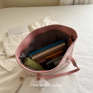 Pink quilted tote bag with spacious interior for umbrella, tablet, and books