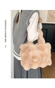 Close-up of fluffy apricot plush tote bag with wavy cloud edges and textured faux fur