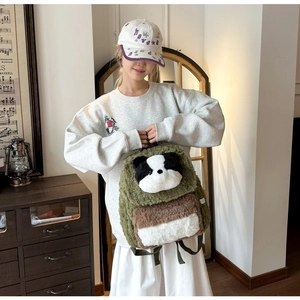 Detail of soft plush panda backpack in olive green lamb wool with cute 3D character design