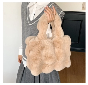 Detail of plush tote bag in beige with soft wavy texture and long faux fur material