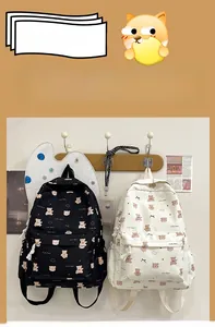 Detail of cute bear pattern canvas backpack showing black and white options for students