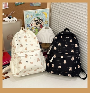 Detail of cute bear printed backpacks with zipper pockets in black and cream nylon
