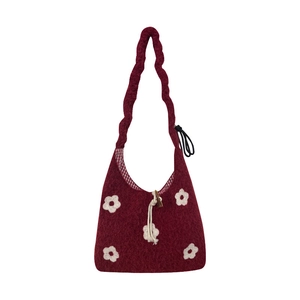 Deep red knit tote bag with white 3D floral accents and twisted woven shoulder strap