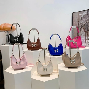Collection of half-moon handbags in multiple colors with silver bow metallic detail