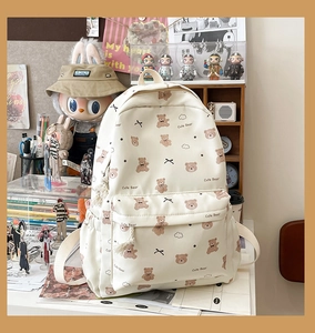 Close-up of cute bear pattern printing and canvas texture on the beige backpack