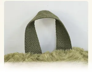 Close-up of military green plush fabric texture and sturdy woven handle on the backpack