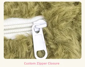 Close-up of durable white nylon zipper and metal slider on green plush faux fur backpack