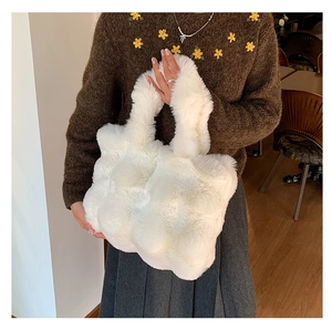 Detailed close-up showing soft texture and fluffy white faux fur material of the plush tote bag