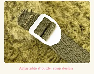 Detail of adjustable green woven shoulder strap with white buckle on plush fabric
