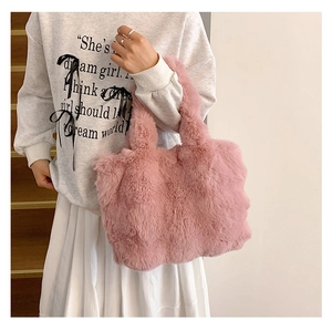 Close-up of pink fluffy plush tote bag showing the soft faux fur texture and thick handles