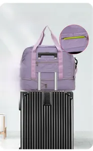Purple waterproof travel bag with functional trolley strap attached to a luggage handle