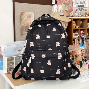 Detail of cute bear prints and front zipper pocket on black high school nylon backpack