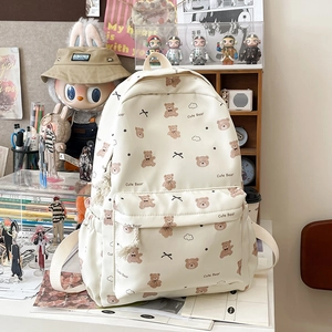 Detail of cute bear printed canvas backpack in cream white with cloud pattern