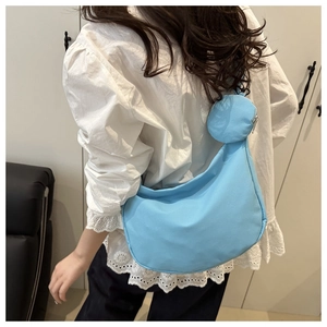 Light blue crescent nylon crossbody bag with matching round coin purse detail
