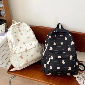 Close-up of cute bear pattern and zip pocket on nylon backpacks in black and white