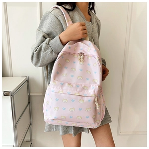 Detailed view of pink canvas backpack with cute cat patterns and bow prints for students