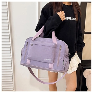 Detail view of the purple fitness travel bag showing durable nylon texture and multi-pockets