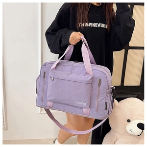 Detailed side view of lavender fitness travel bag with shoulder strap and large pockets