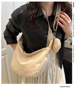 Detail of beige nylon hobo bag with adjustable wide strap and round coin purse