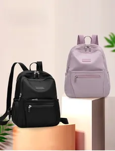 Front view of stylish nylon backpacks in black and light purple for daily commuting