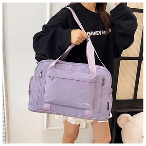 Modern light purple nylon travel bag with adjustable strap and large front pocket