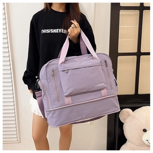 Close-up of a stylish purple gym bag showing waterproof fabric and a zippered pocket