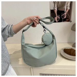 Detail of mint green waffle pattern crescent bag with detachable round coin purse