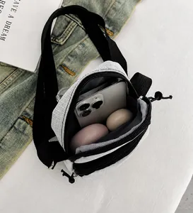 Detail view of the multi-compartment casual crossbody bag showing phone storage space