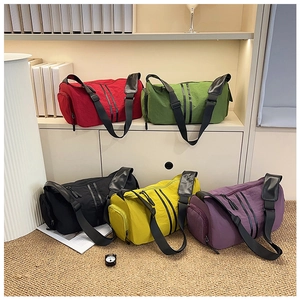 Detailed view of colorful nylon yoga duffel bags in red, green, black, yellow and purple
