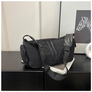 Detail view of black nylon yoga bag with side zipper and athletic double webbing stripes