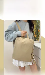 Side view of model wearing a khaki nylon backpack with textured fabric and side zipper