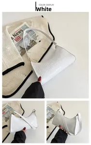 Detail view of white croc-embossed hobo bag with vintage minimalist crescent design