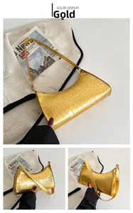Detailed views of a gold crescent bag with crocodile pattern and stylish shoulder strap